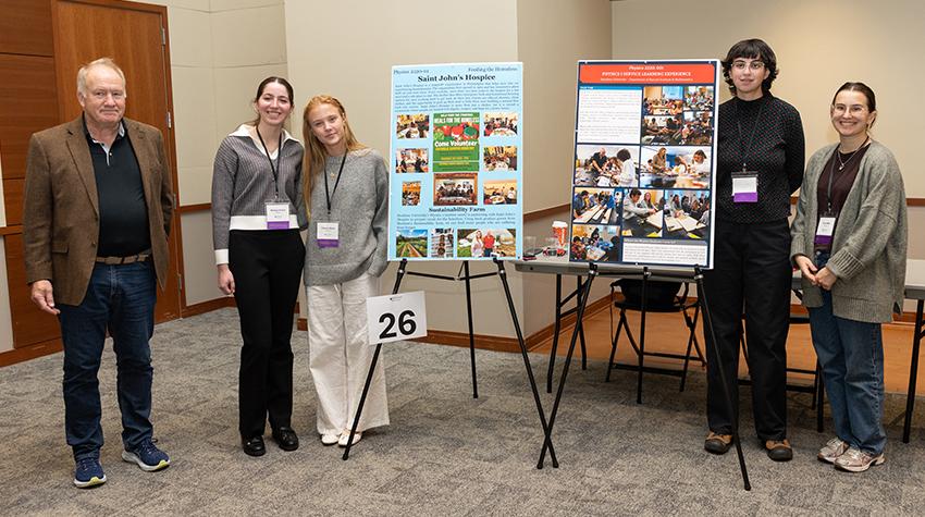 Laura Penepentto and her group in front of their presentations Laura Penepentto and her group in front of their presentations