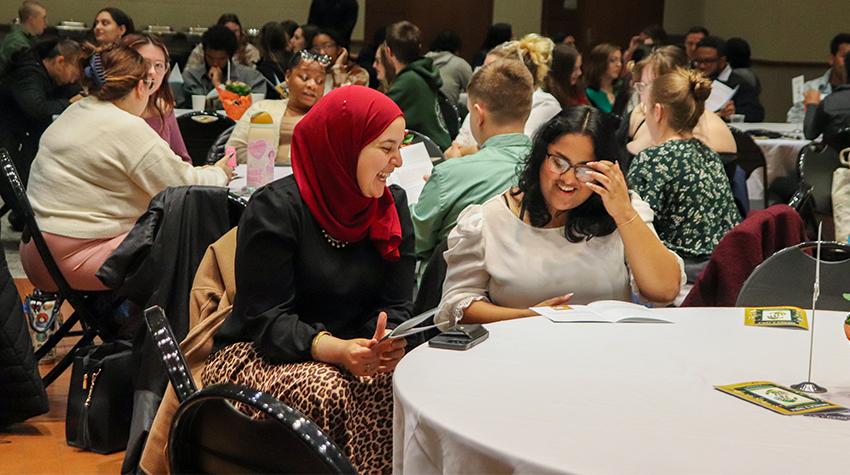 A faculty member talking with a student during the dinner A faculty member talking with a student during the dinner