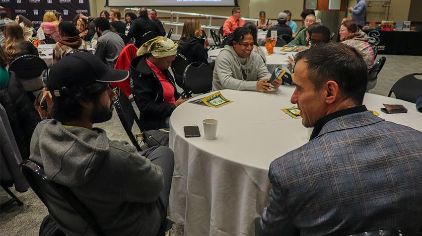 A faculty member talking with a student during the dinner A faculty member talking with a student during the dinner
