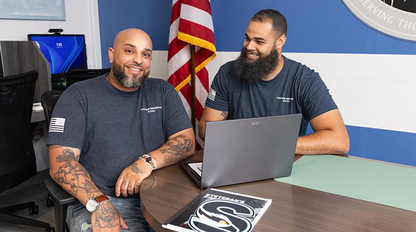 Two student veterans posing for a photo Two student veterans posing for a photo
