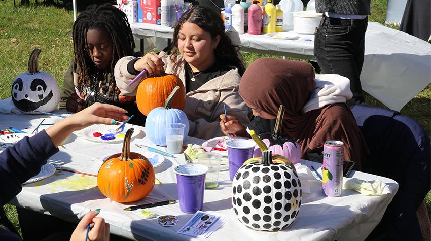 Students painting pumpkins during Party in the Park Students painting pumpkins during Party in the Park