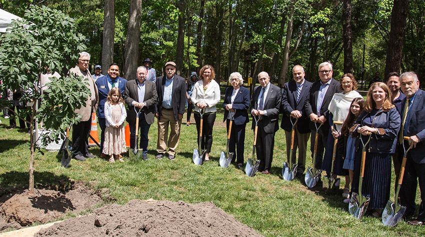 Attendees posing for a photo following the planting Attendees posing for a photo following the planting