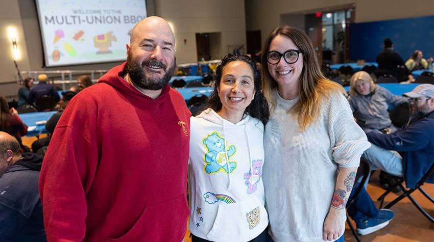 Staff members posing for a photo at a Tri Union BBQ Staff members posing for a photo at a Tri Union BBQ