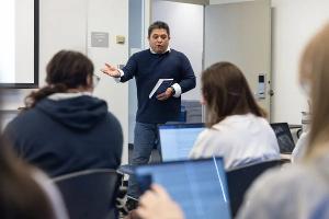 A Literature professor leads an engaging class discussion, encouraging close reading and thoughtful analysis of texts.