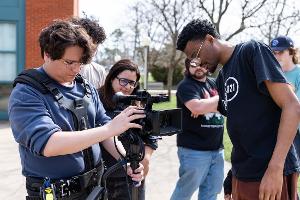 Communication Studies students at Stockton University receive hands-on training with professional video cameras in a campus media production studio.