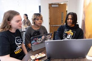 Students working together in Stockton University’s Digital Studies program, discussing ideas and building digital projects.
