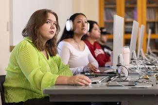 Digital Studies students at Stockton University working in a computer lab, developing multimedia and technology skills through hands-on projects.