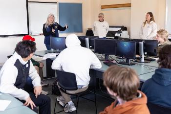 Students learn environmental data analysis and mapping techniques in a technology-equipped lab environment.
