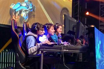 Students compete on stage in a live esports event, experiencing the energy and professionalism of large-scale tournaments.