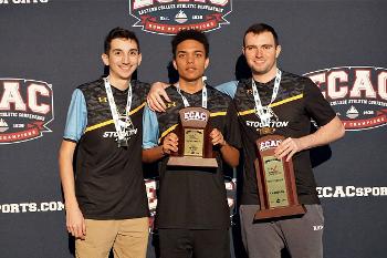 Stockton University esports team members celebrate a championship win, showcasing competitive success and program excellence.