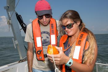 Hands-on learning at sea as students use field equipment to measure and monitor marine conditions.