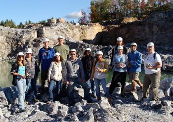 Students in Stockton University’s geology program analyze rock samples at an active quarry site, gaining hands-on experience in mineral identification and field methods.