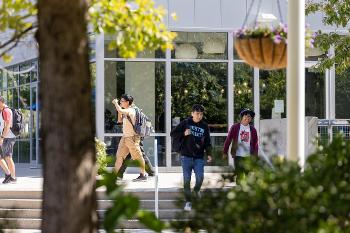 Stockton University students walk across campus between classes, preparing for careers in accounting, finance, and business leadership.