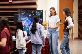 Stockton University Teacher Education students present an interactive learning project during a student showcase event.