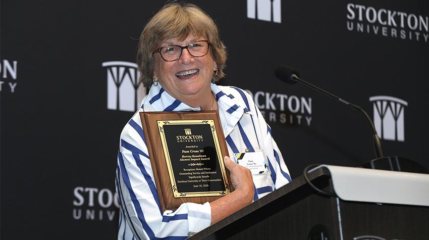 Pam Cross '81 showing off her award during her remarks