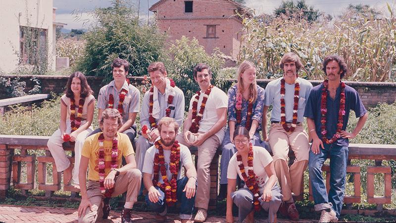 Bert and his colleagues in Nepal, adorned with flower wreaths. Bert is in the front row, center.