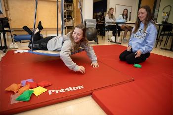 Stockton occupational therapy students work with therapeutic equipment in the lab, gaining experience with movement, positioning and activity-based approaches that connect academic learning with occupational therapy practice.
