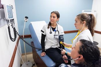 Stockton nursing students practice patient assessment and vital-sign techniques in a realistic clinical learning environment.