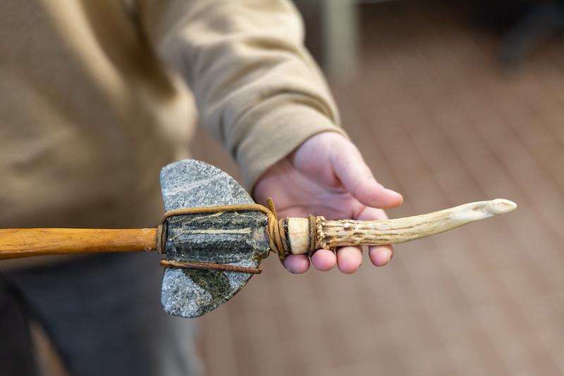 Archaeology student examining a recovered artifact