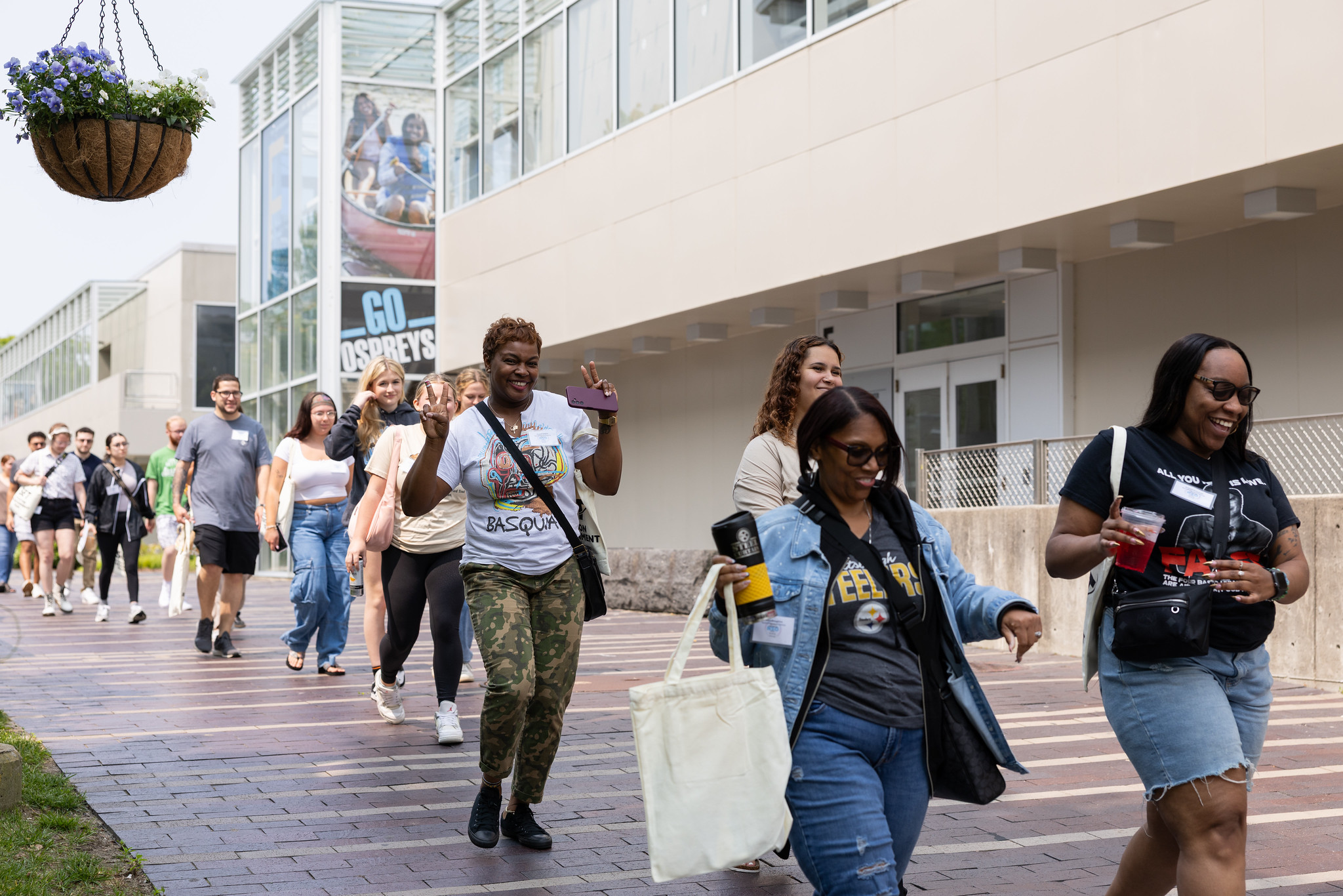 students smiling while walking to course registration
