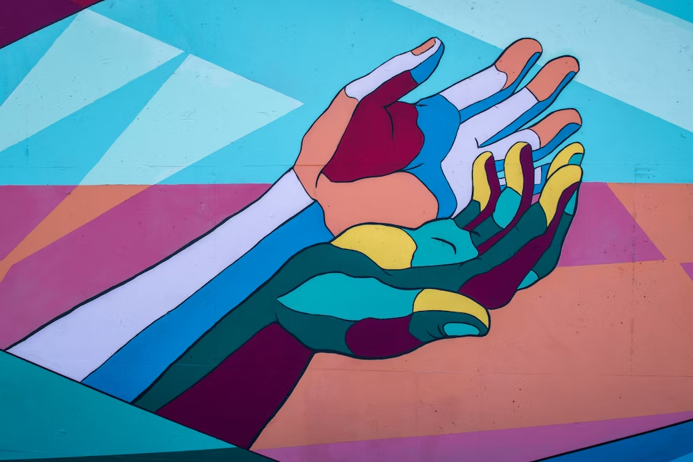 Two colorful animated hands extended outwards with one hand on top of another.