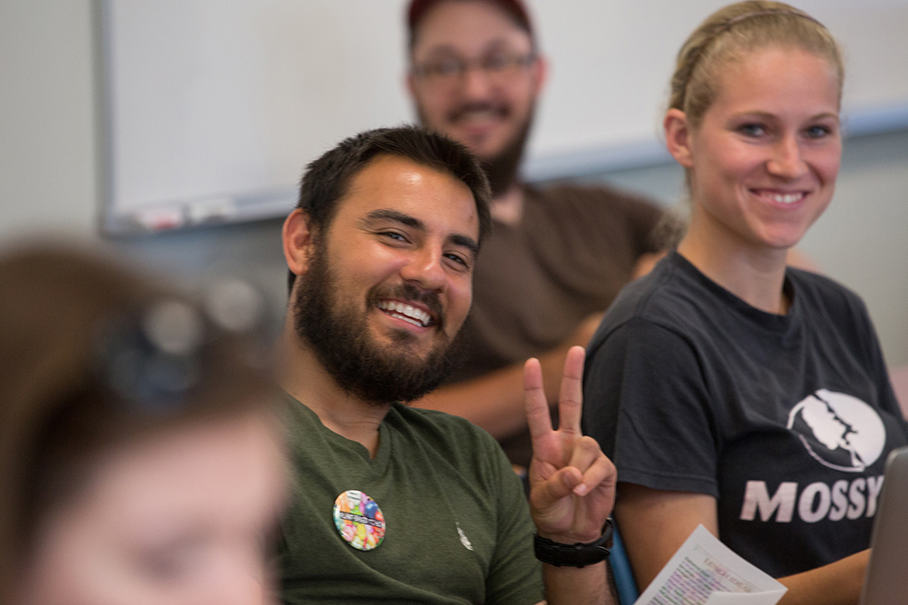 student giving peace sign