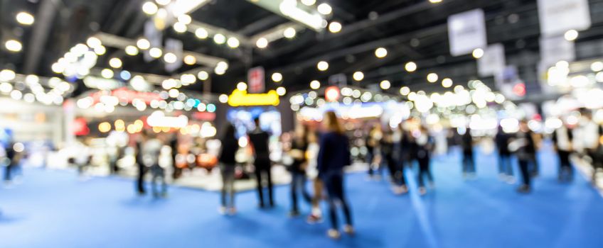 Out of focus wide view of trade convention exhibit space 