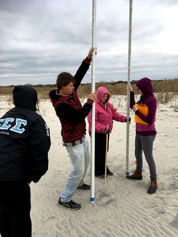 Stockton student researchers conducting beach profiling