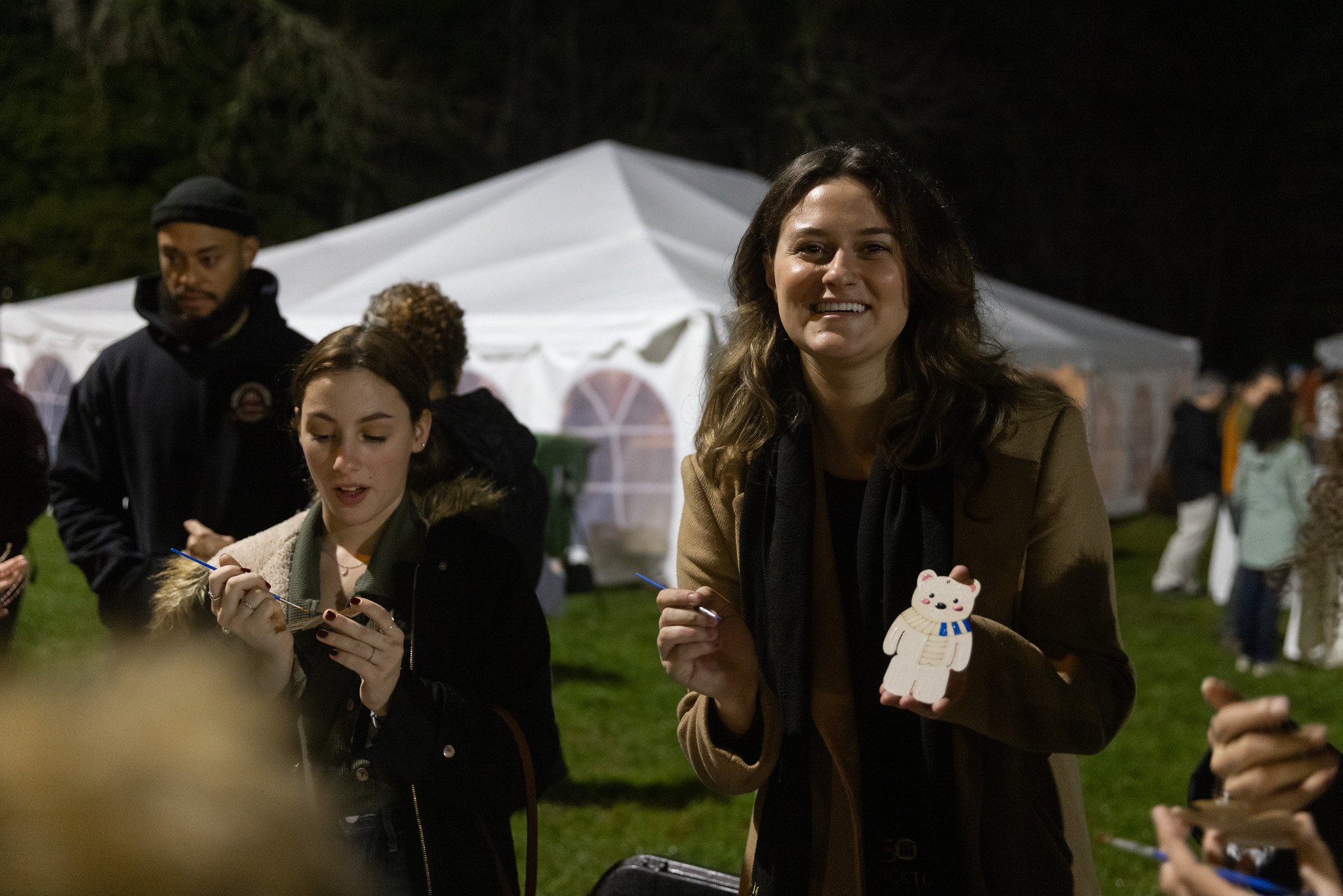 Brianna Bracey, president of the Stockton Student Senate, holds up an ornament she decorated at the Winter Tree-dition. 