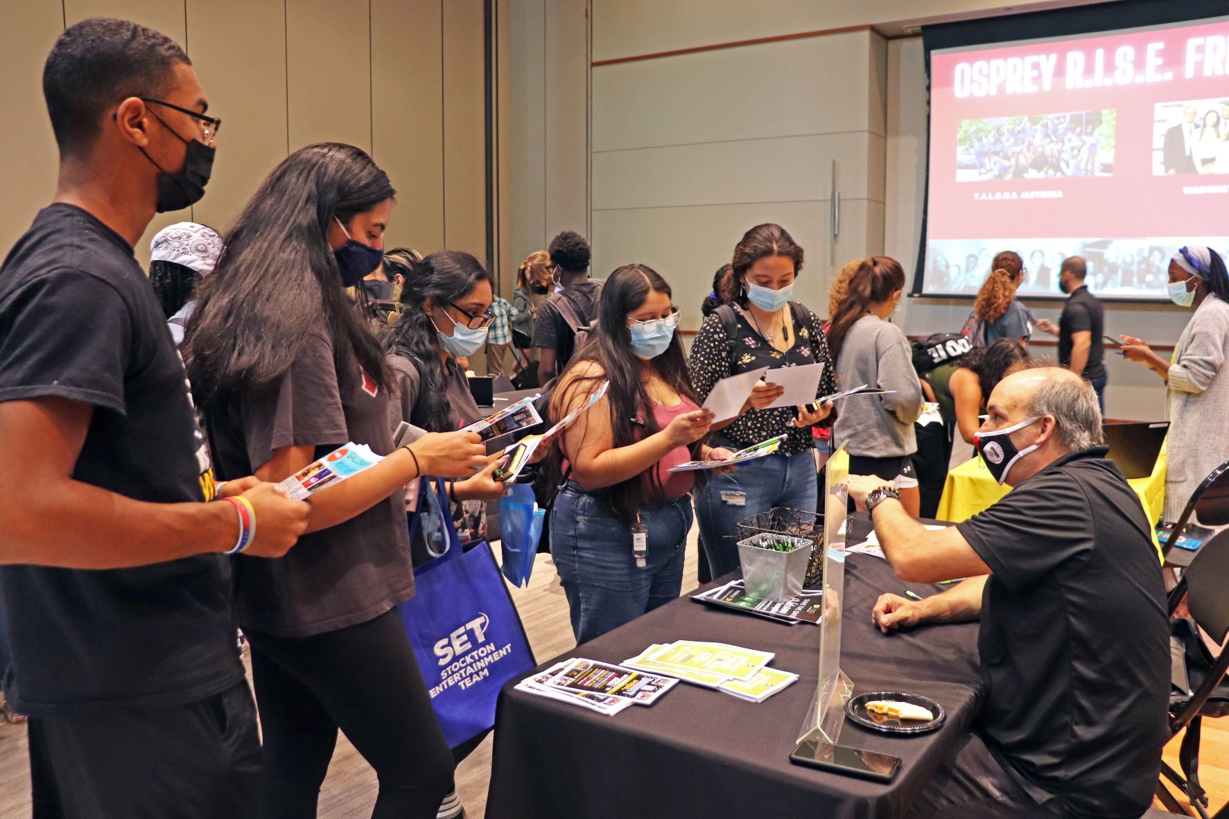 A group of students speak with Jeffrey Wakemen, Director of Student Development, about ways to get involved on campus.