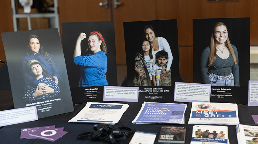 Portraits of female veterans on display for the Office for Military and Veterans' table. 
