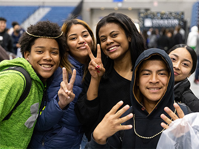 Britney Reyes and her friends posing for the camera and smiling.