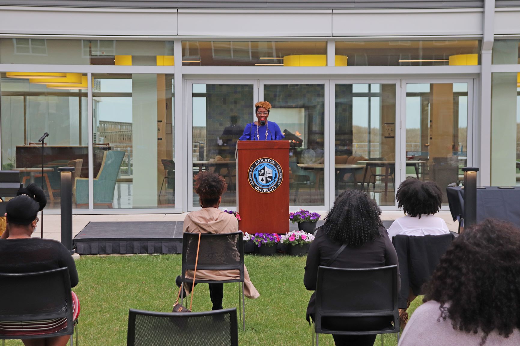 Nordia Johnson, director of Academic Achievement Programs at Stockton University, stands at the podium addressing students.