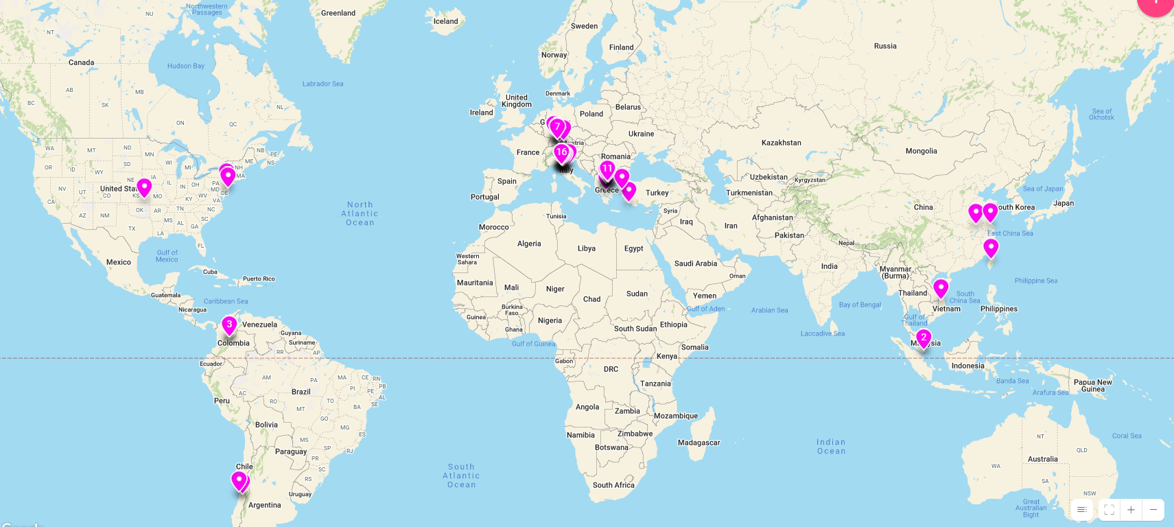 A digital map of the world shows red pins in various countries, representing the hometowns of participants at Stockton University's world language tables.
