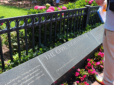 Flowers surrounding the placard for the Civil Rights Garden