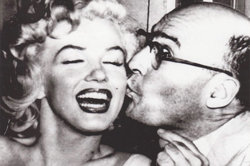 Marilyn Monroe getting a kiss on the cheek by Al Gold