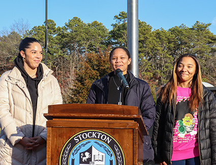 Janet Martin at the podium with Kira (left) and Tamara (right)