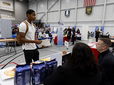 Student talking to recruiters at the Career Fair