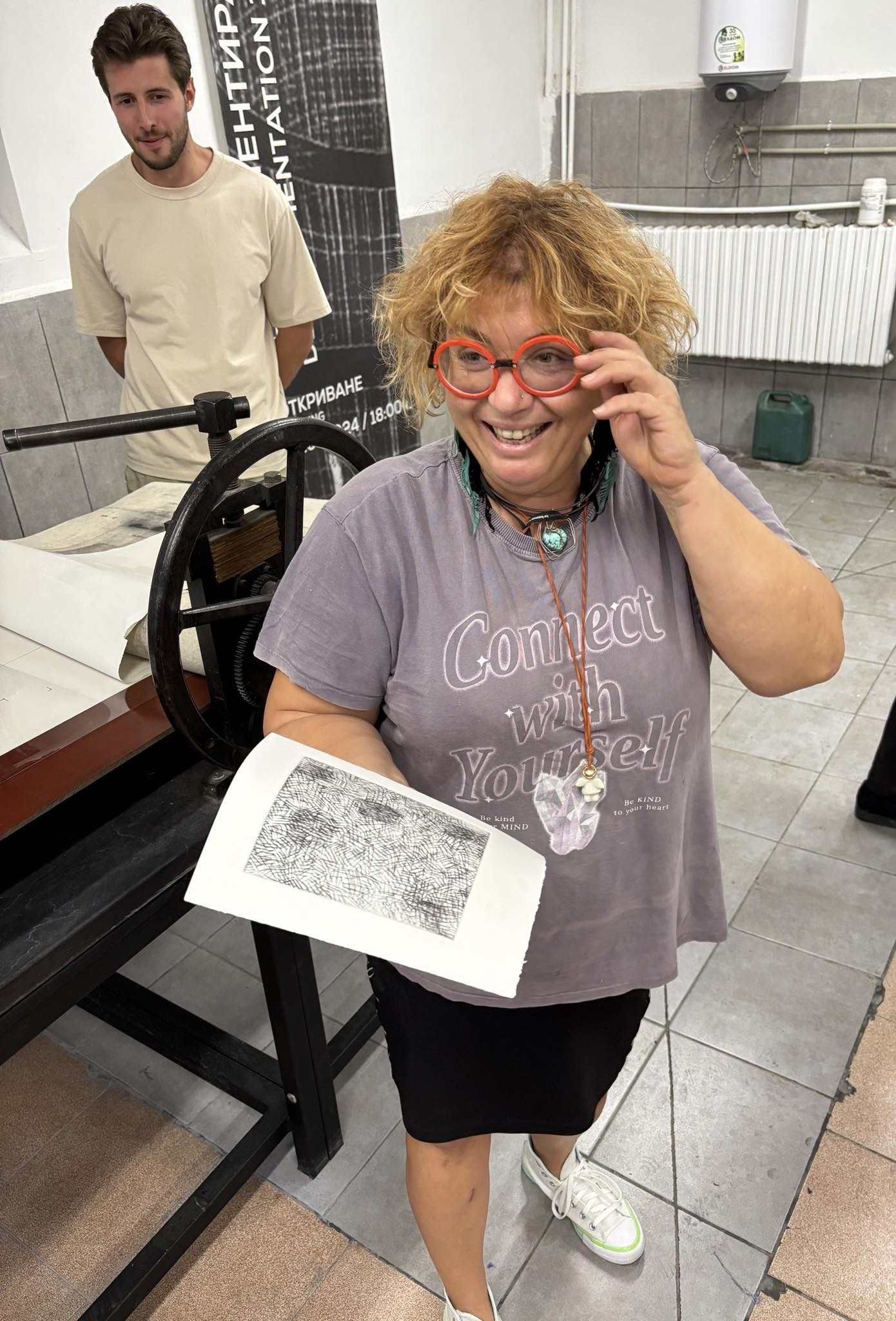 Desislava Hristova-Tosheva holds a print during a 2024 photoengraving workshop with artist Fatima Conesa.