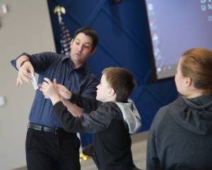 Magician Chad Juros '11 teaches magic tricks to children. 