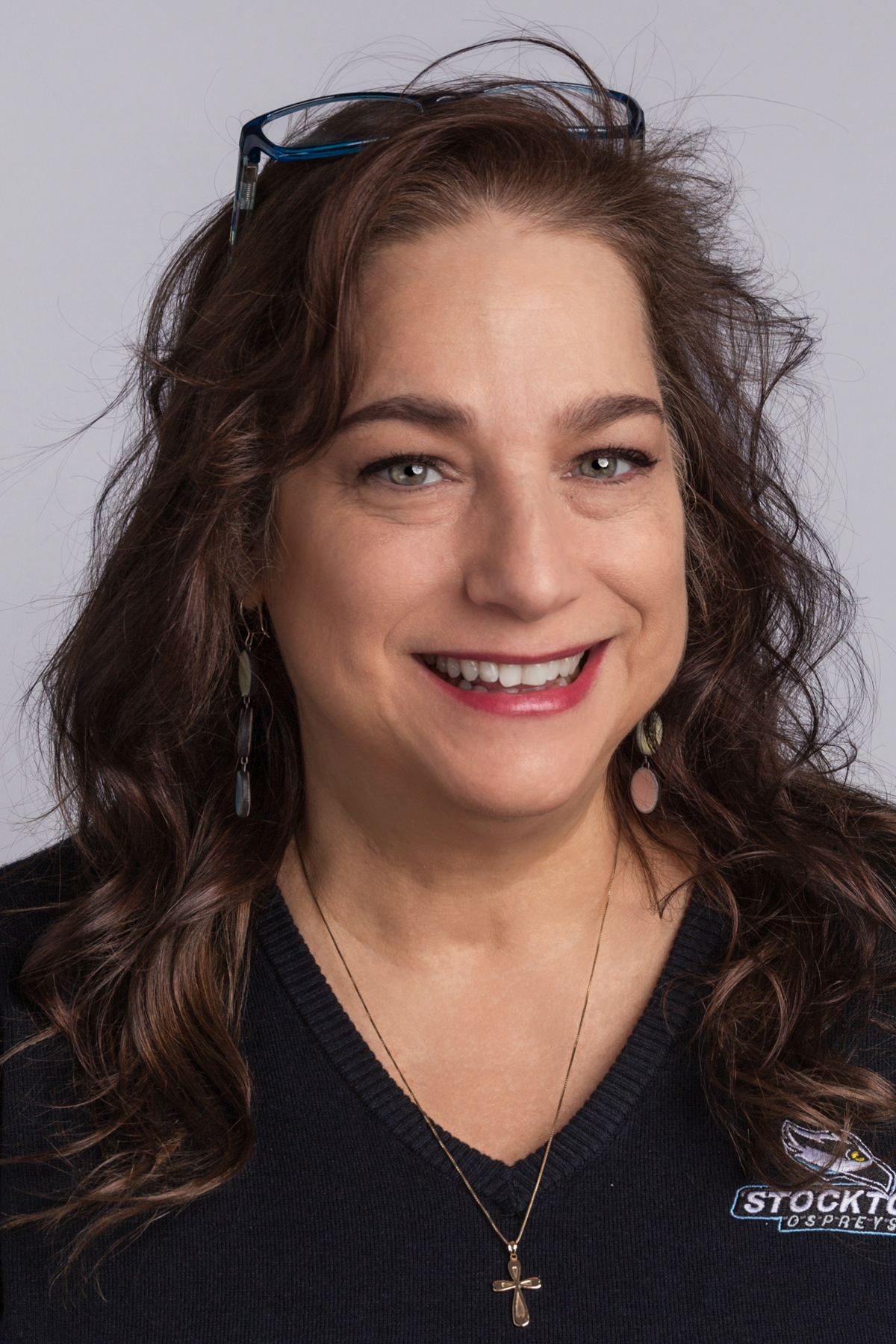 woman in black shirt smiles