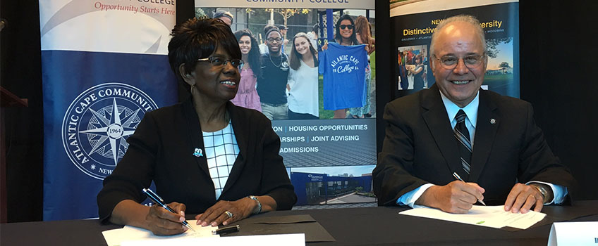 Stockton President Harvey Kesselman and Atlantic Cape President Barbara Gaba sign a partnership agreement.