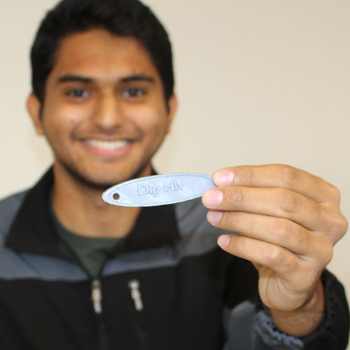 Deep Halvawala Computer Society club treasurer shows off the keychain he printed during a Computer Society workshop.