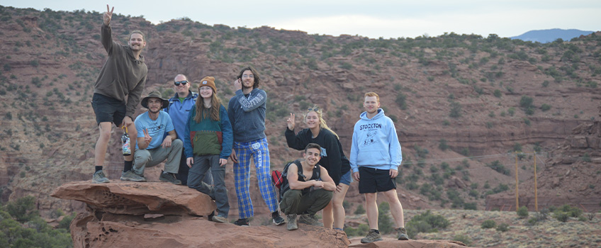 Twenty students in Stockton's Geology Club spent two weeks exploring the unique geography around Utah and Colorado. Pictured are a group at Panorama Point in Capitol Reef National Park in Utah watching the sunset. 