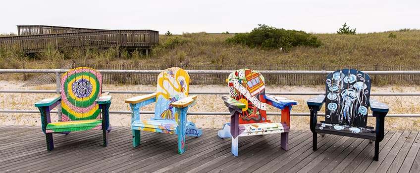 These chairs were designed and hand-painted by four Ospreys: (L-R) Ian Lawrence, Faeryn Meza, Caitlyn "Frenchy" Hroncich, '23, and Camryn Wilson.