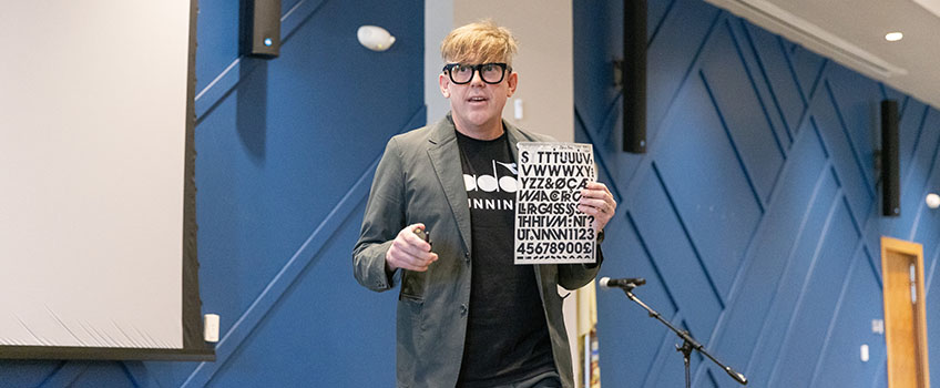 Bryan Poerner receives an award from School of Business Interim Dean William Minnis
