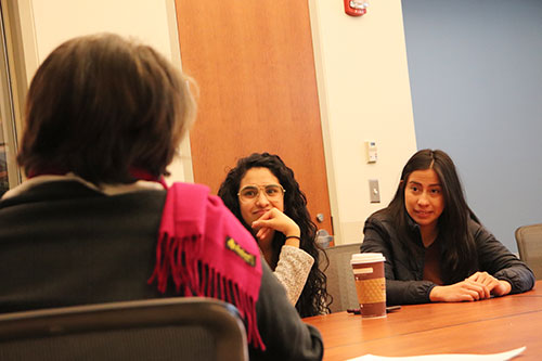 two exchange students listening to faculty member from Cololbia