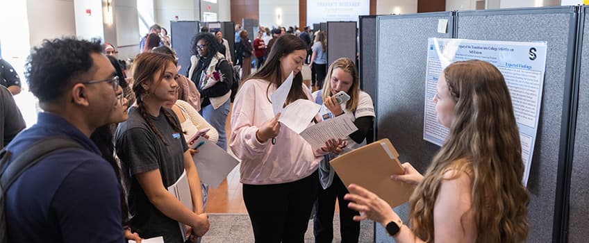 Stockton students presenting projects at graduate research symposium