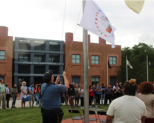 Los Unidos flag raising