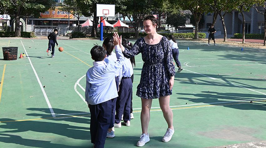 Sara McShea giving a high five to a student during recess